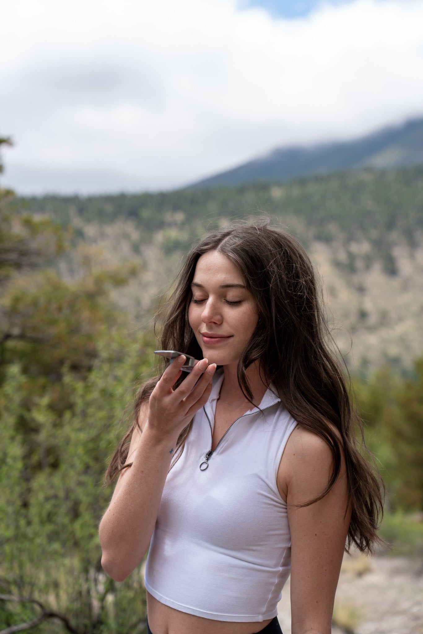 Woman smelling solid fragrance outdoors